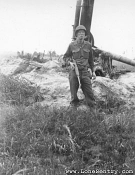 [GI with Abandoned German Flak Gun]